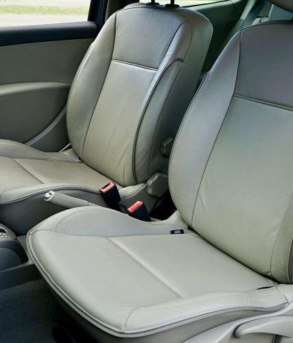 Spacious car interior featuring contemporary leather seats and a steering wheel.